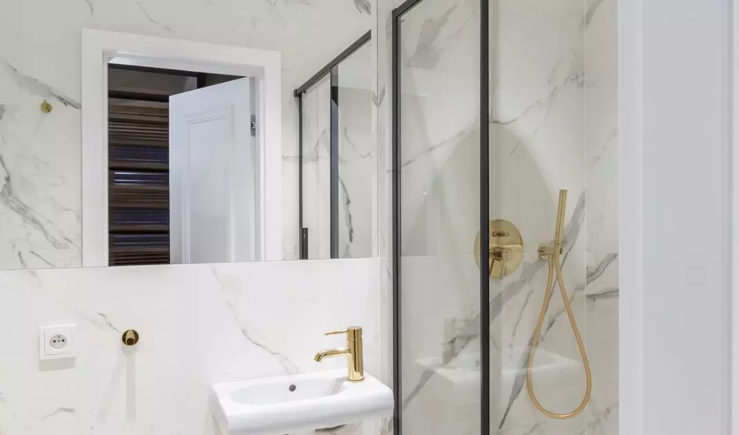 The decor of the first floor bathroom is consistent with the kitchen