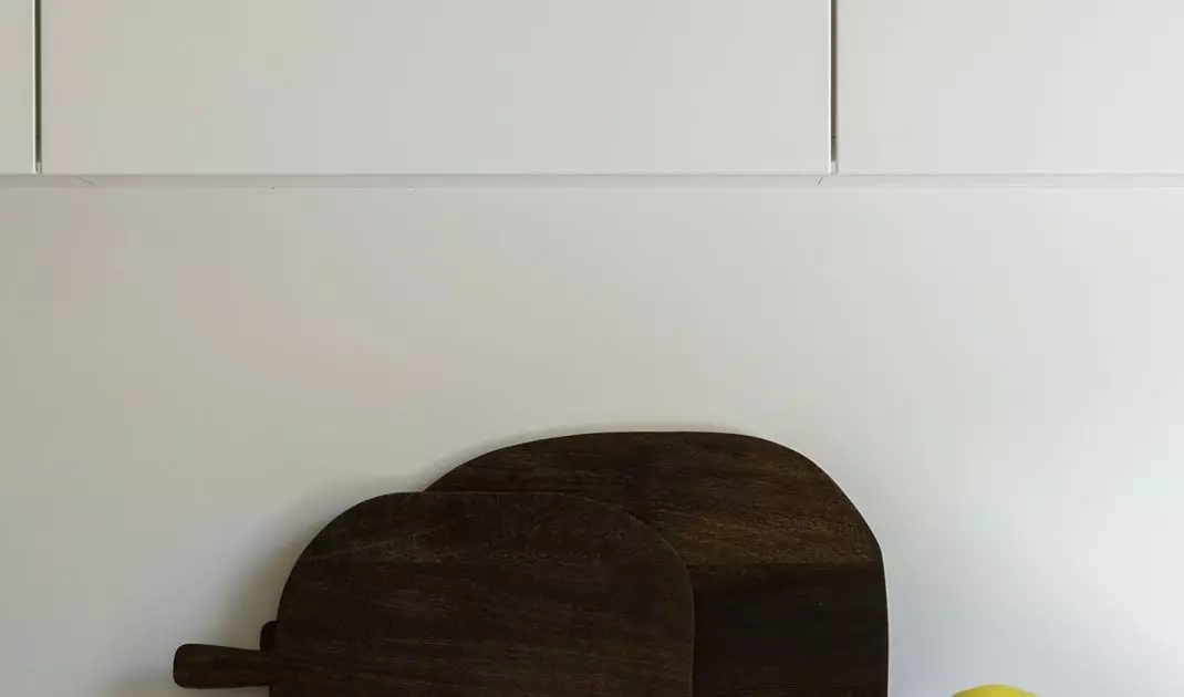 White cabinetry is combined here with black cabinets