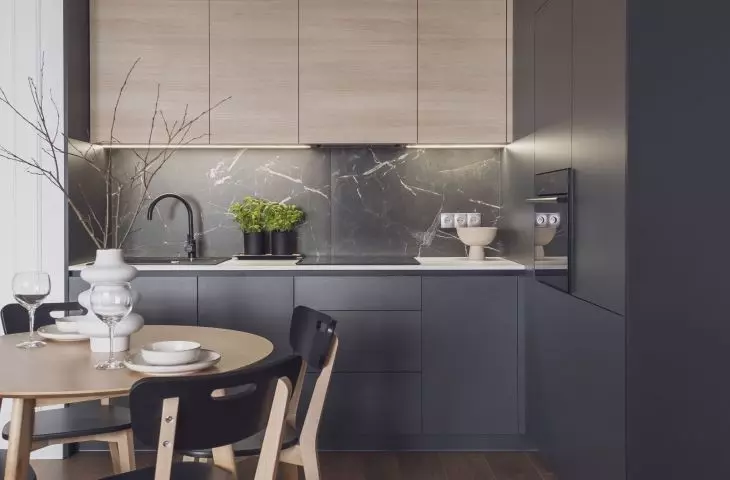 Dark kitchen flows seamlessly into dining room 