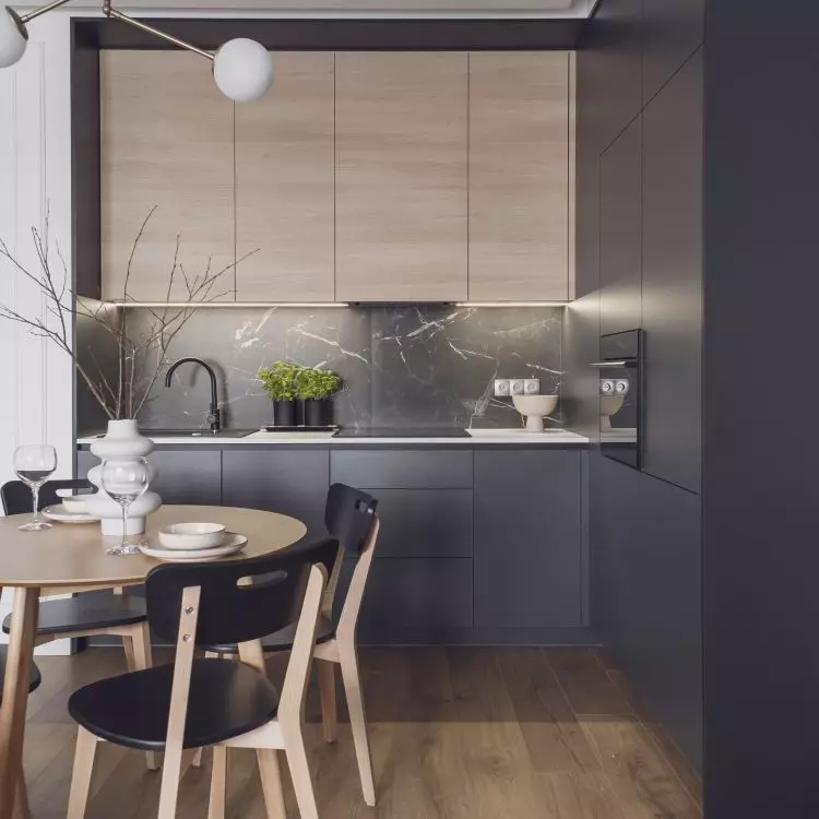 Dark kitchen flows seamlessly into dining room 