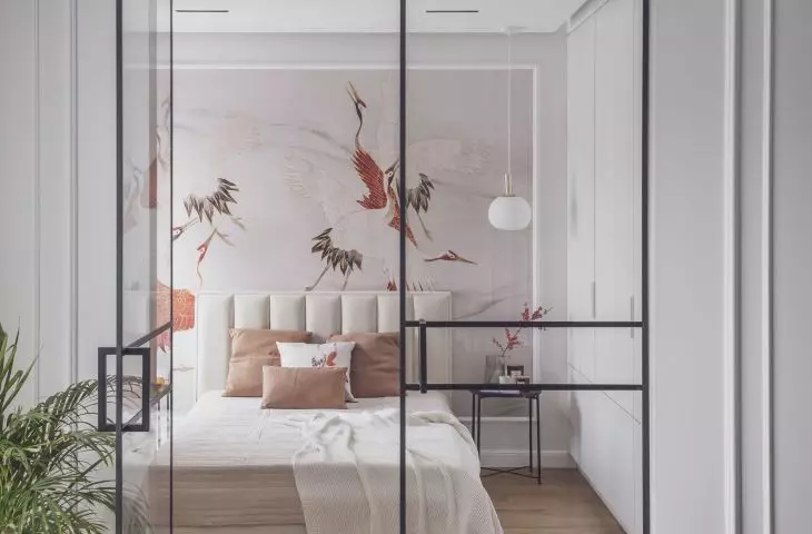 The wall behind the bed was decorated with striking wallpaper