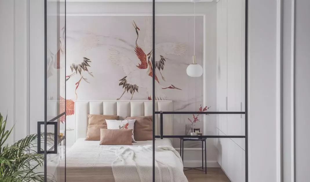 The wall behind the bed was decorated with striking wallpaper