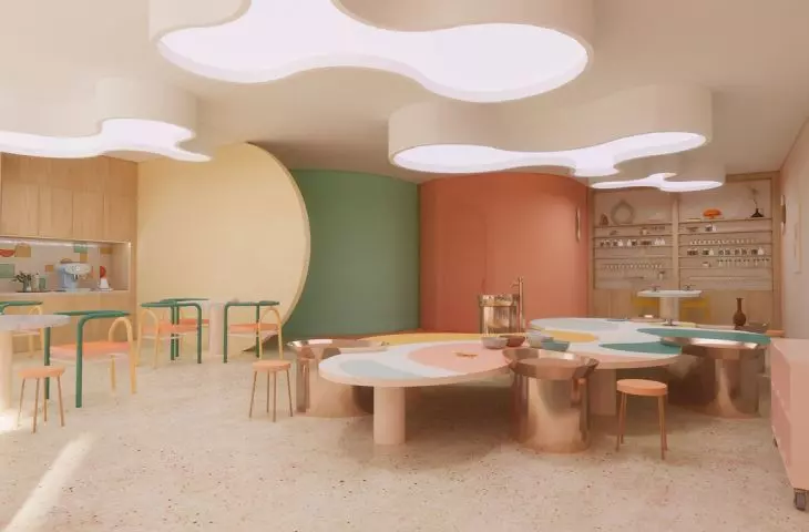 The center of the studio is a table with potter's wheels, which has curves on the edges and graphic stains on the tabletop