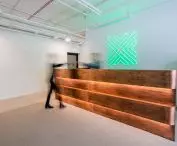 from the entrance to the office the eye is drawn to the counter covered with copper sheets