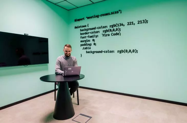 the wall is decorated with code fragments made of acoustic felt material