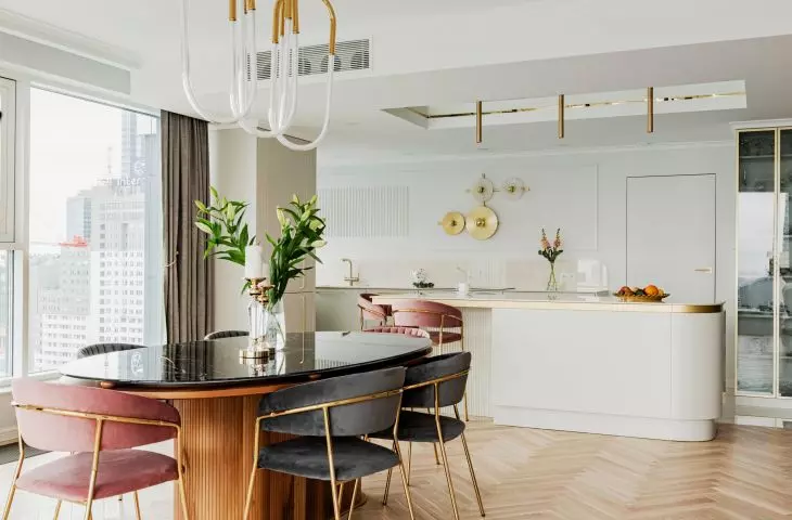 The dining room table is a combination of wood and marble 