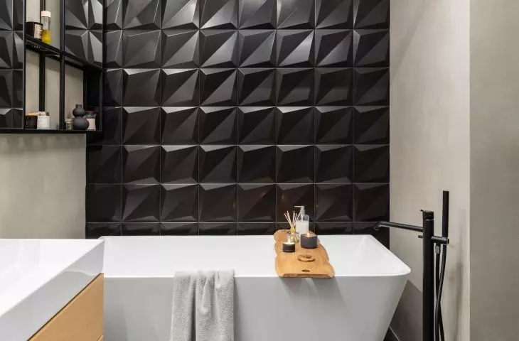 The wall was decorated with black 3D tiles
