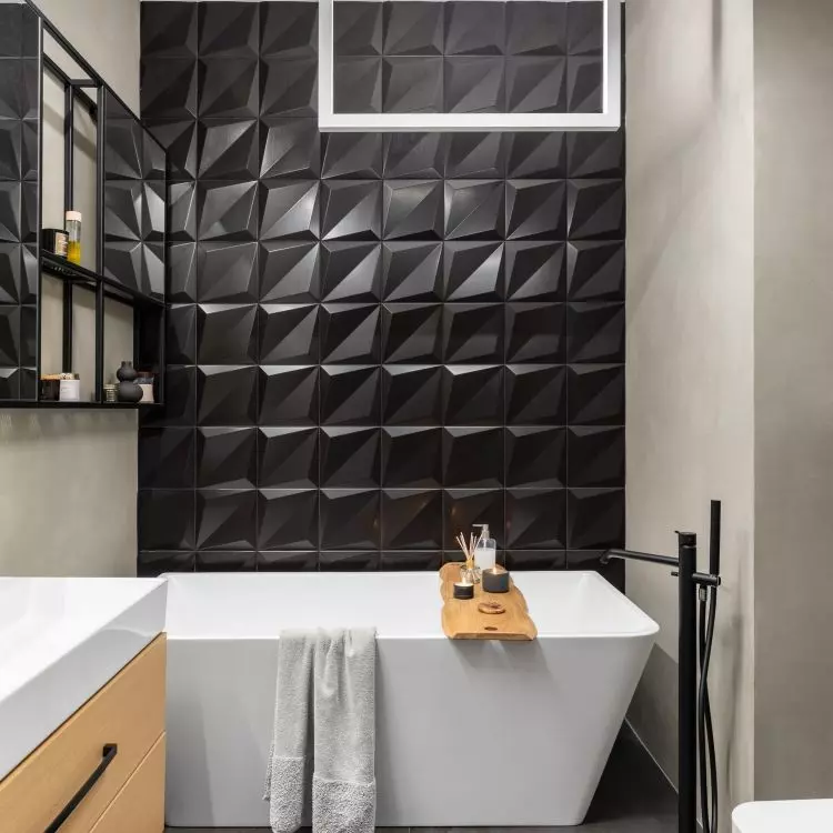 The wall was decorated with black 3D tiles