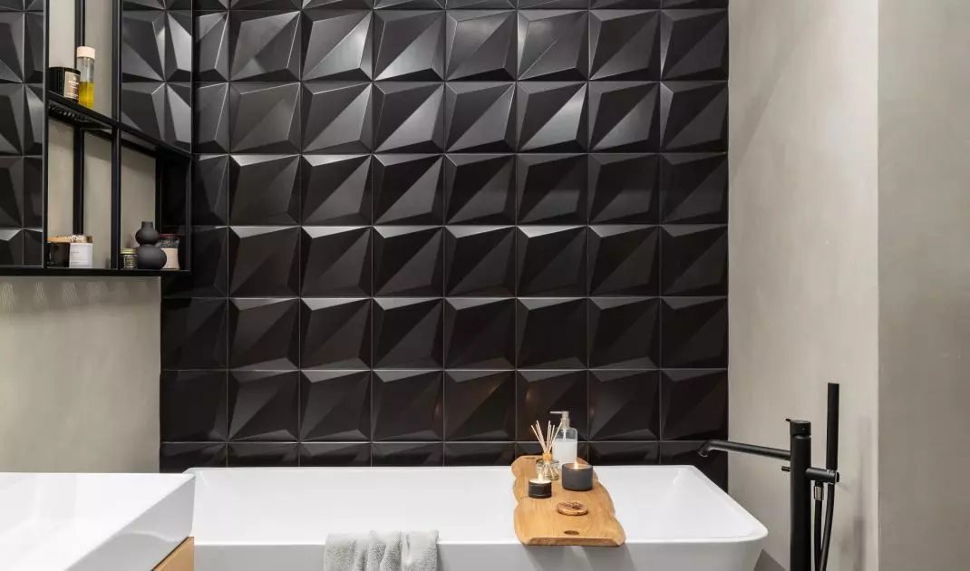The wall was decorated with black 3D tiles