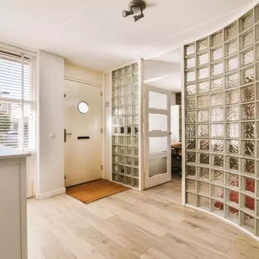 Luxafers are once again making a comeback in interiors. A wall of glass blocks is a striking way to divide even small spaces.