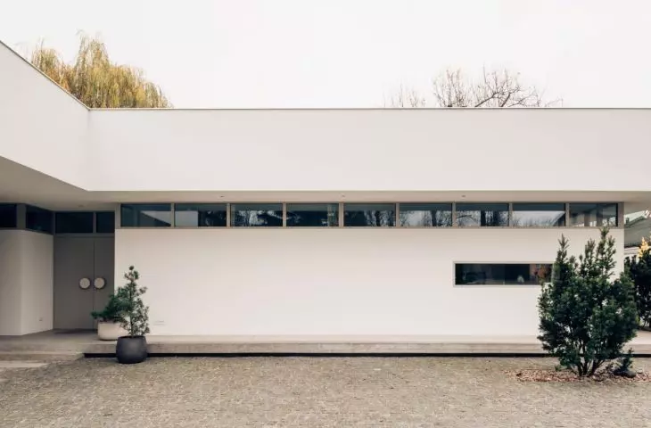 horizontal divisions are emphasized by a strip of longitudinal windows illuminating the interior 