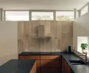The whole house is lit by a narrow strip of windows under the ceiling