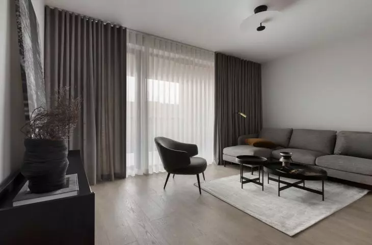 The focal point of the living room is a graphite couch