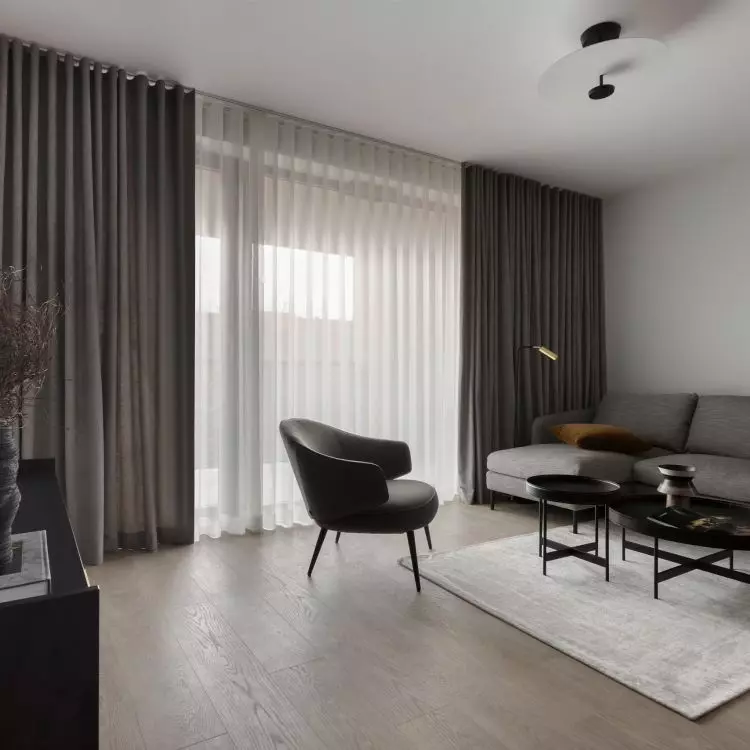 The focal point of the living room is a graphite couch