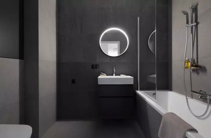 The bathroom is kept in the colors of black