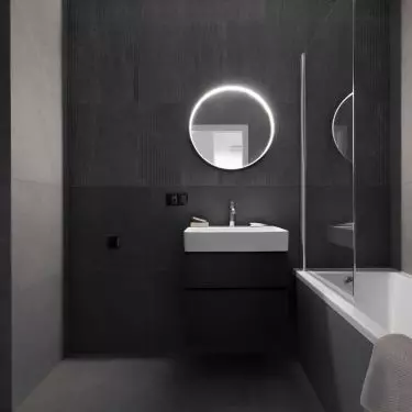 The bathroom is kept in the colors of black