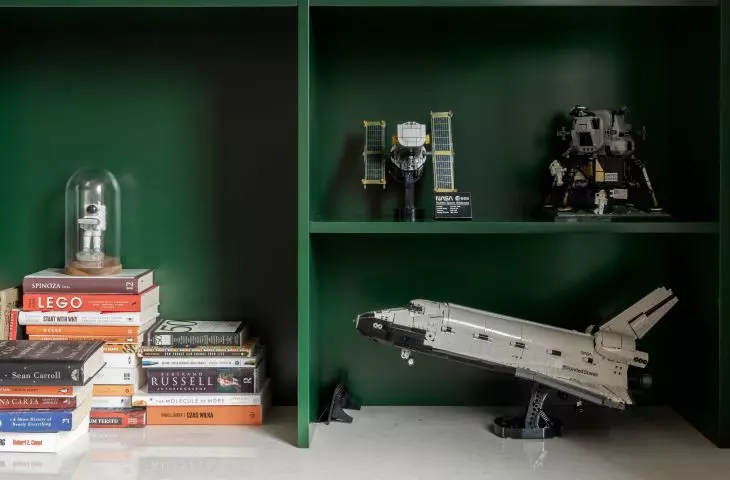 Dark green bookcase sets the tone for the office arrangement