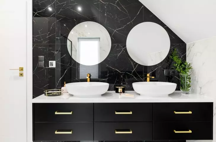 The sinks are located on a black cabinet