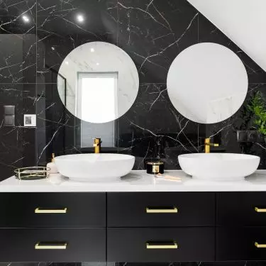 The sinks are located on a black cabinet