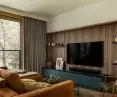 One of the walls of the living room is lined with wood