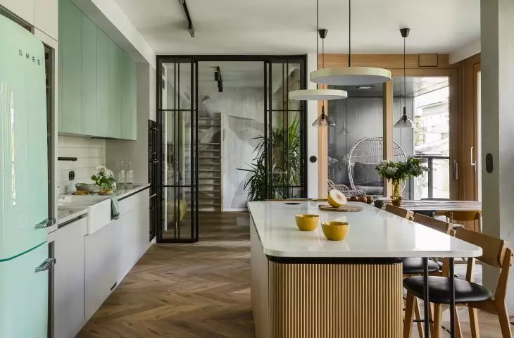 Inside the kitchen, the eye is drawn to the mint fridge