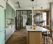 Inside the kitchen, the eye is drawn to the mint fridge