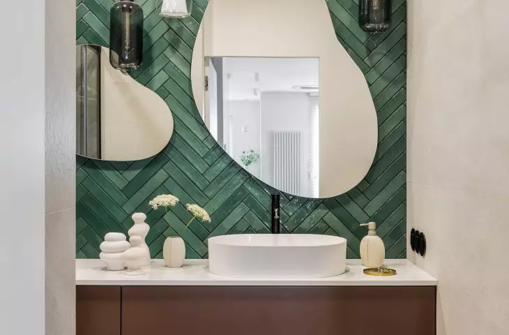 The first floor bathroom was tiled with green tiles laid in a herringbone pattern