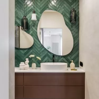 The first floor bathroom was tiled with green tiles laid in a herringbone pattern