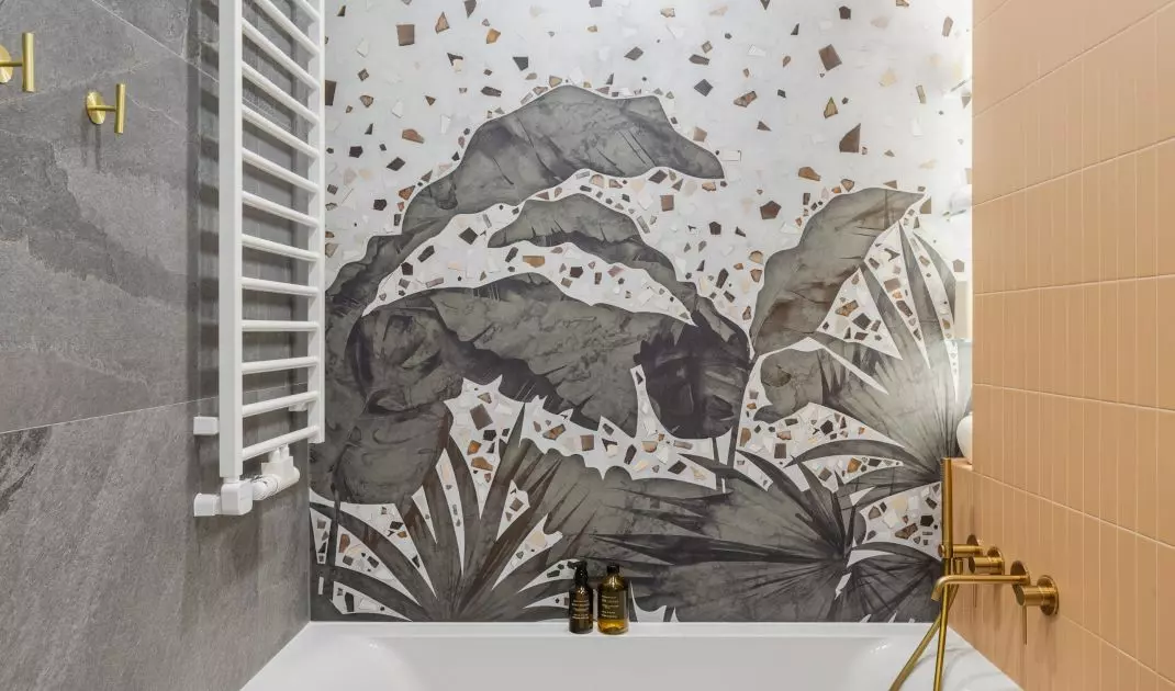 Upstairs bathroom stands out with wallpaper over bathtub