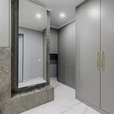 The utility room fits stylistically into the bathroom design