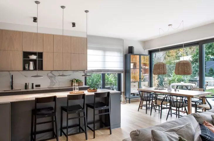 The kitchen has a peninsula with a marble countertop