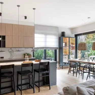 The kitchen has a peninsula with a marble countertop