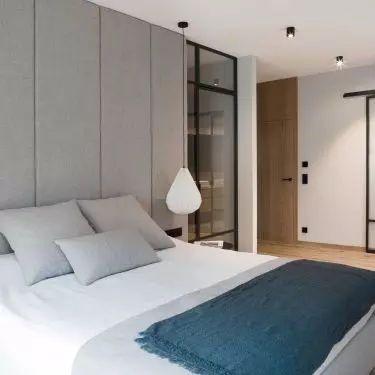The headboard of the bed was covered with the same material that appears on the bed