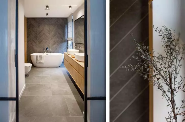The wall behind the bath has been decorated with herringbone tiles