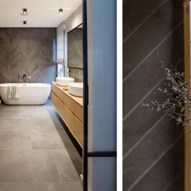 The wall behind the bath has been decorated with herringbone tiles