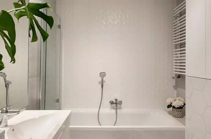 The bathroom has a bathtub with a screen