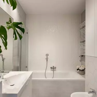 The bathroom has a bathtub with a screen