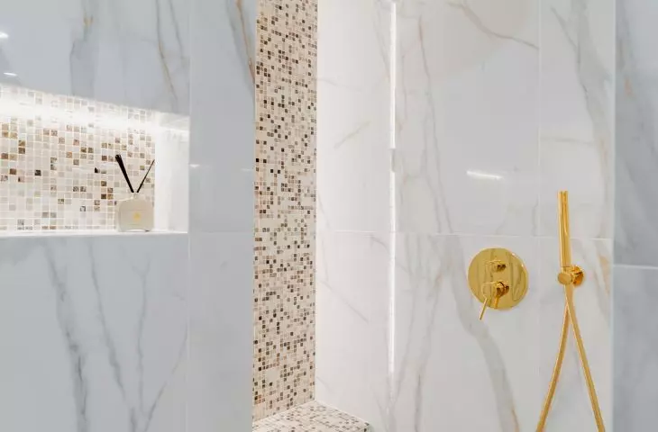 The shower area has been delineated with mosaic tiles