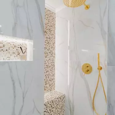 The shower area has been delineated with mosaic tiles