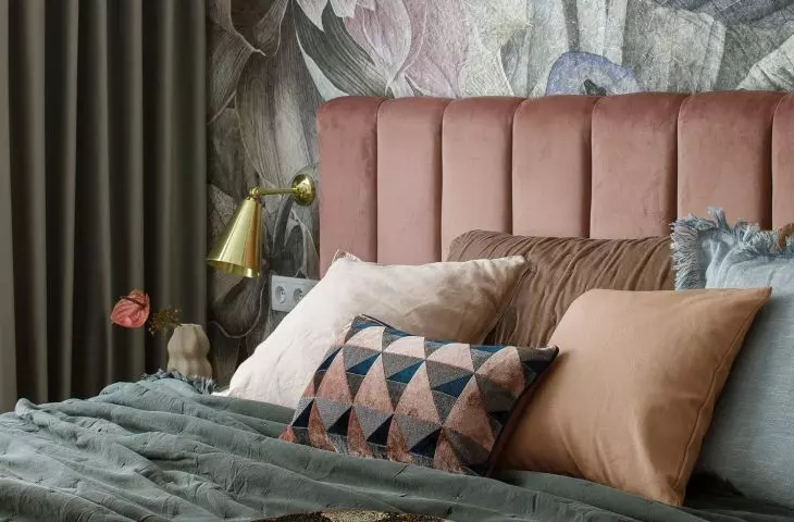 The wall behind the bed was decorated with wallpaper in large flowers