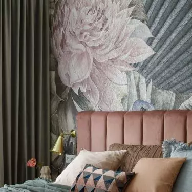 The wall behind the bed was decorated with wallpaper in large flowers
