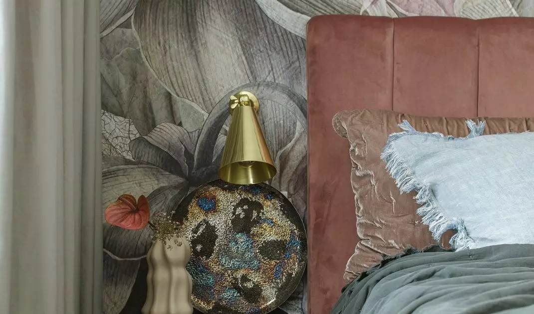 The bedroom is dominated by a combination of pink, orange, bottle green and cool blue