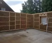 na przygotowanej płycie fundamentowej z modułów drewniano-słomianych powstają ściany i nadproża budynku