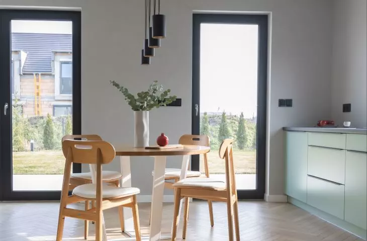 The dining area is located between the kitchen and the living room