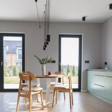 The dining area is located between the kitchen and the living room