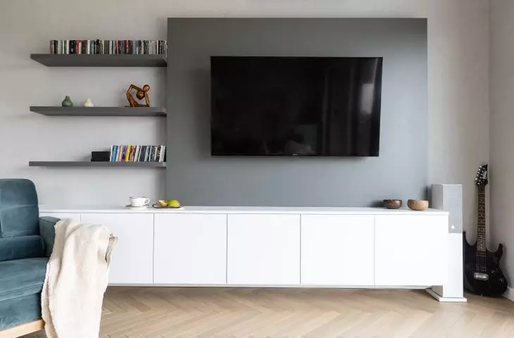 Under the TV is a large white cabinet