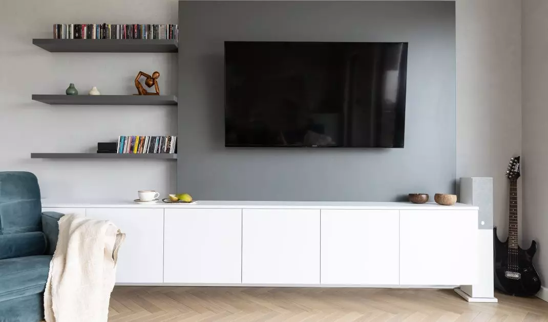 Under the TV is a large white cabinet