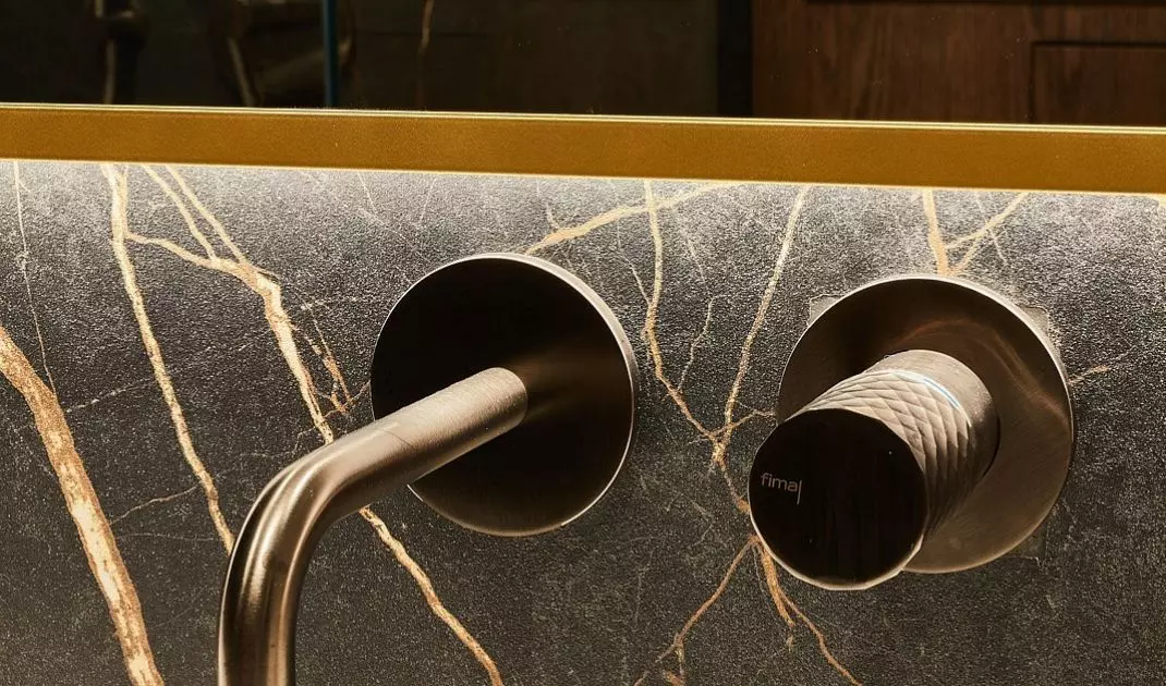 The walls and floor have been covered with large-format tiles with decorative stitching