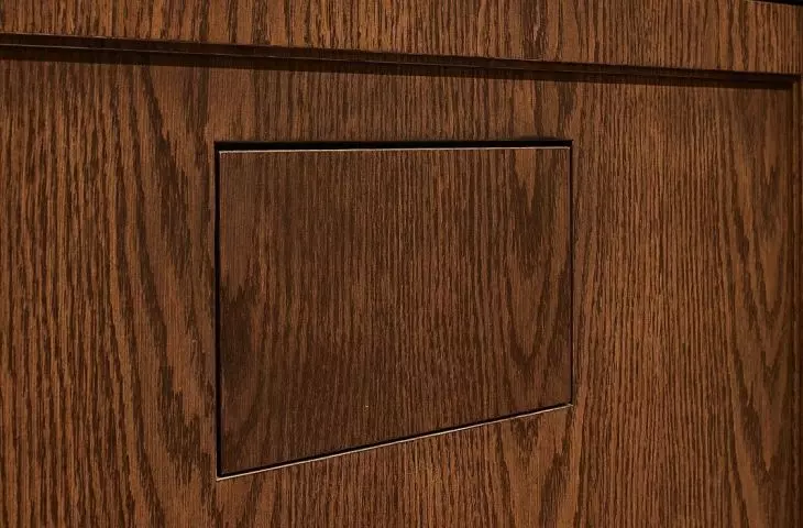 Flat toilet button blends with the wall 