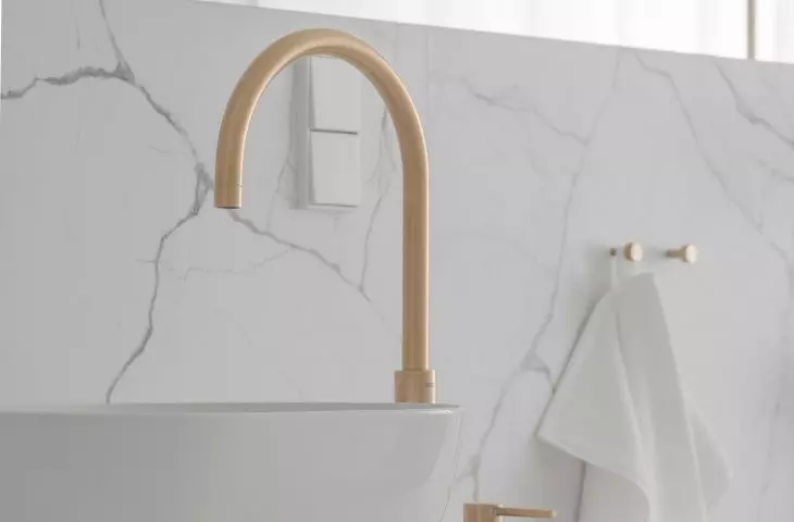 Rounded basins complement gold faucets